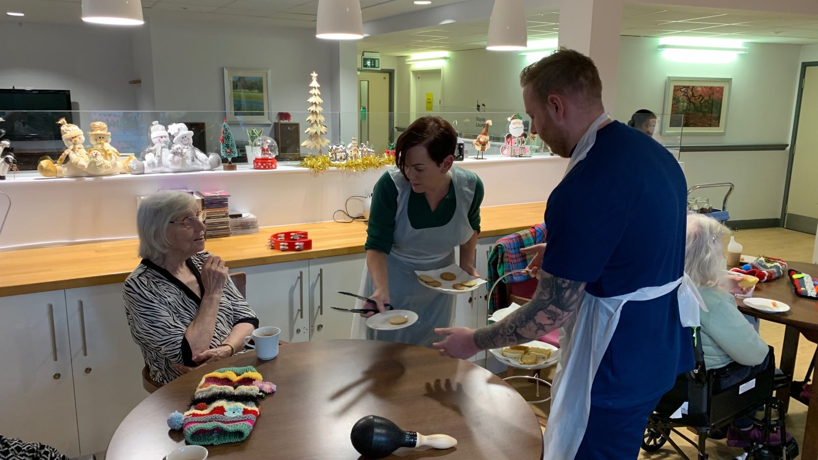 Jack Pringle, from SSFC, helps Sarah Sasmazer dish up cake to Haven Court's residents..jpg